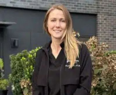 Vet doing a wellness exam on a little dog.