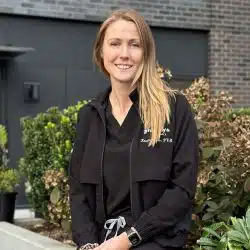 Vet doing a wellness exam on a little dog.